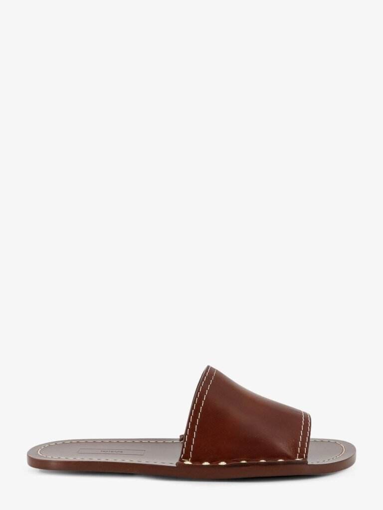 Low leather sandals with metal studs on the sides