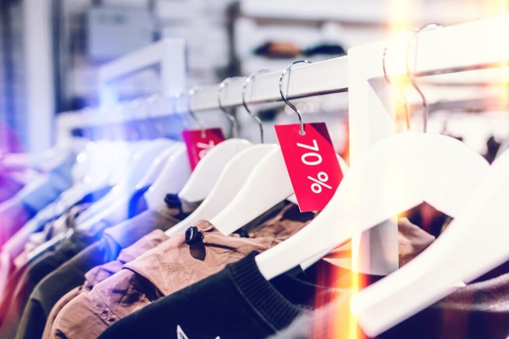 Clothing rack with 70% sale markdown tags during end-of-season fashion sale