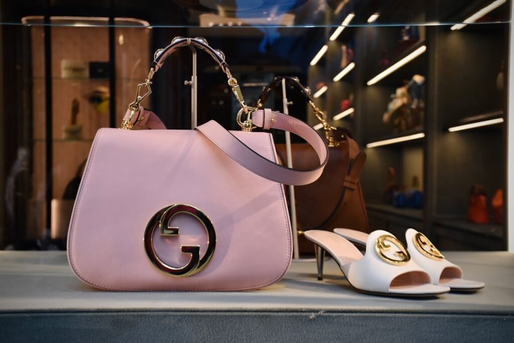 Gucci designer handbag and mule shoes displayed in a luxury boutique window